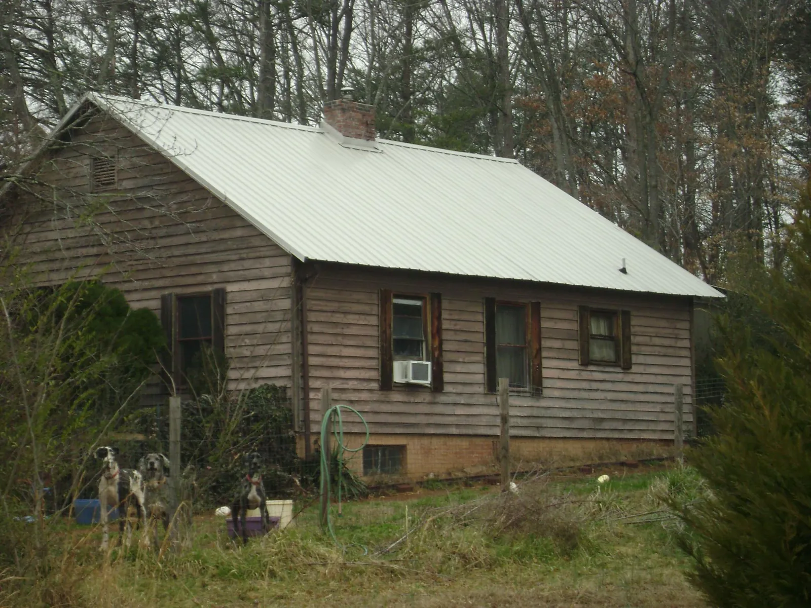 White metal roof on an old wood sided farmhouse, from a Metal Roof Installation job in Allenport